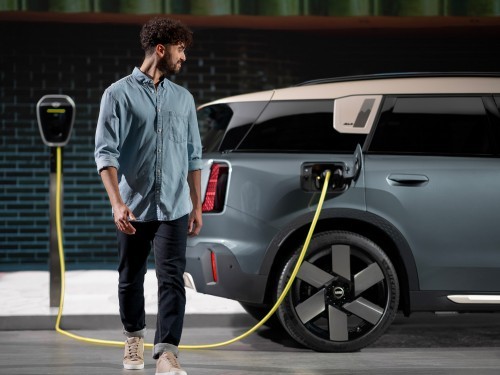 Man charging the all-electric MINI Countryman